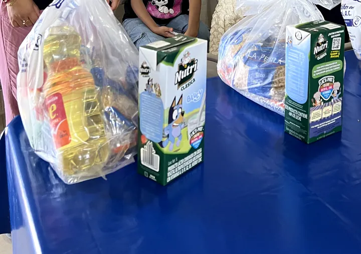 Bags of groceries and cartons of milk on a table at VIFAC Los Cabos