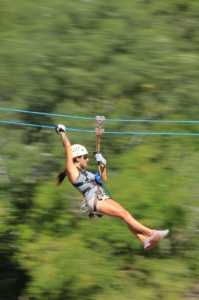 Guest riding a zipline on the Outdoor Adventure tour