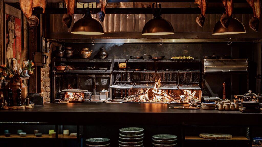 The open kitchen at Lumbre with the fire lit, San José del Cabo