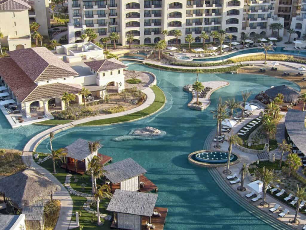 Grand Solmar Pacific Dunes Resort — aerial view of the winding river pool with palapas and loungers