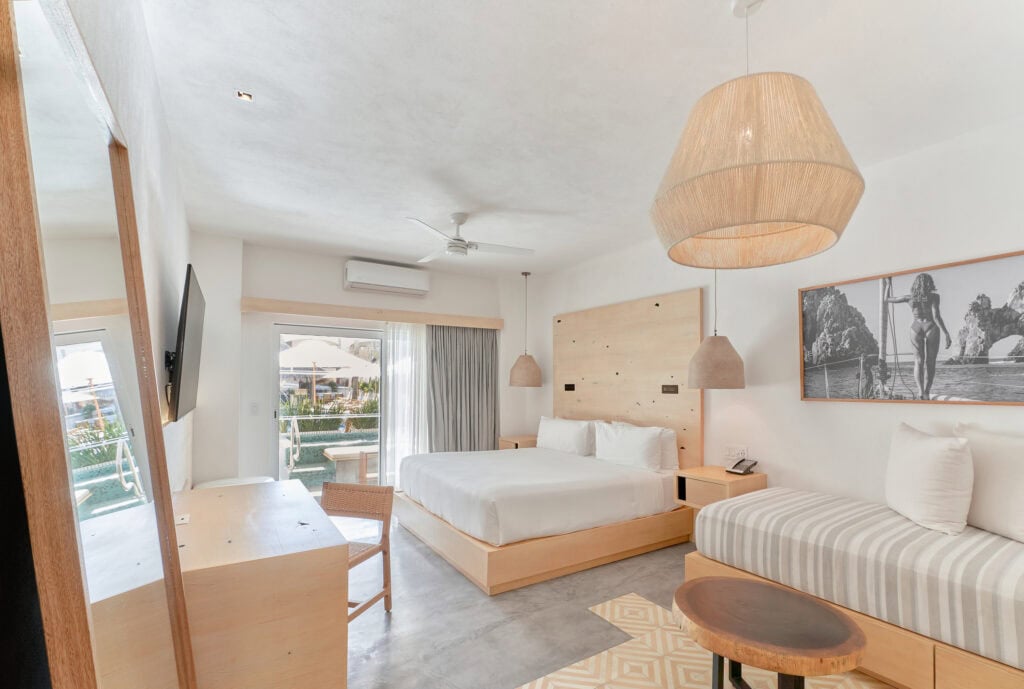 Bahia Hotel & Beach House — guestroom with a bed, sofa and balcony opening to the sea