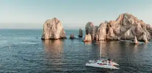 EcoCat catamaran sailing past the Arch at Land's End, Cabo San Lucas
