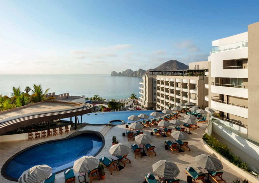 Corazón Cabo Resort & Spa — circular pool and loungers with the resort terraces and Land’s End beyond