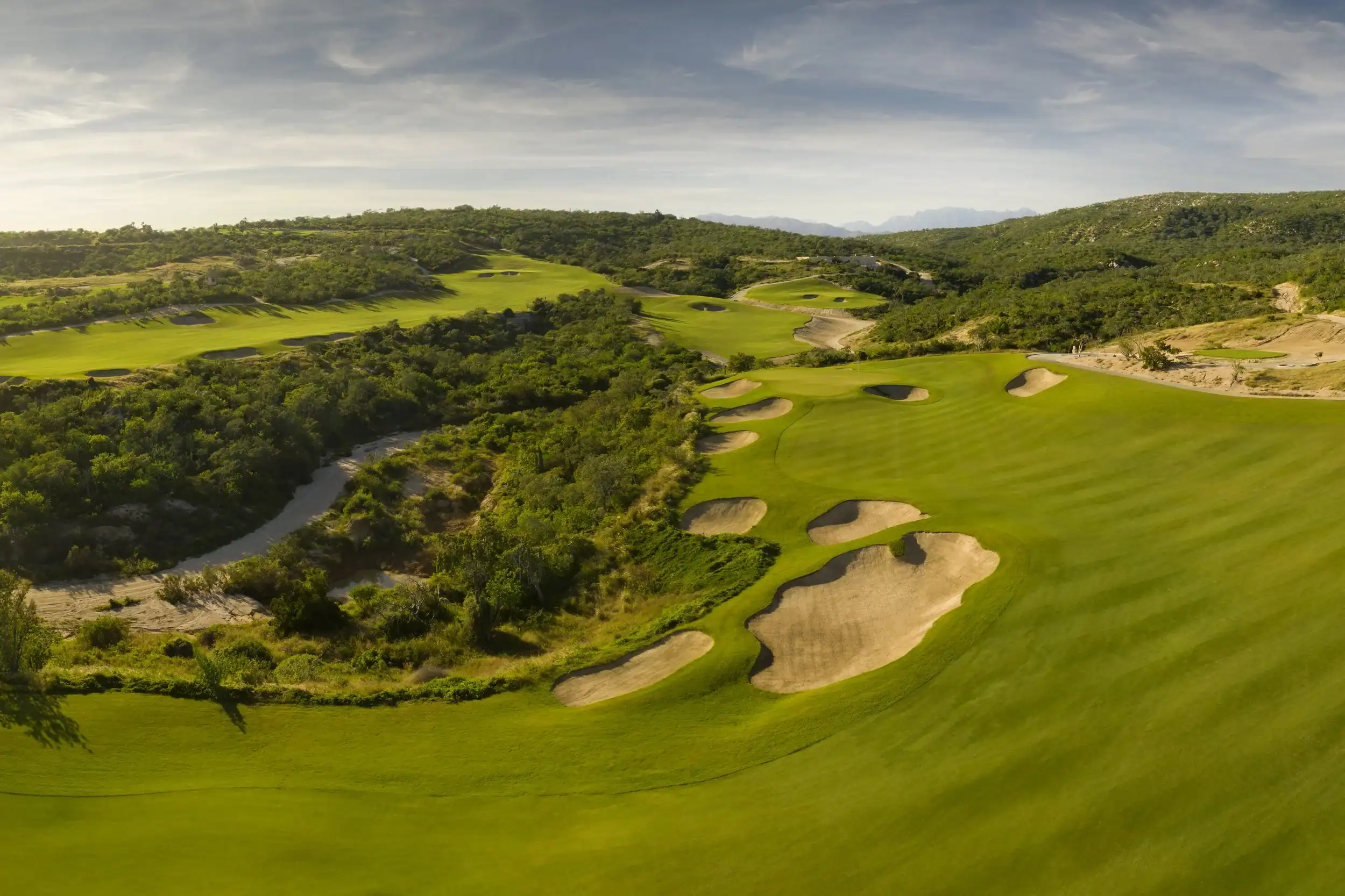 Puerto Los Cabos fairway framed by native hills, water and desert vegetation