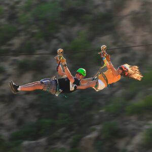 Tandem riders on the Monster Ziplines over the Baja canyon at Wild Canyon Adventures