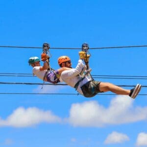Adult and child riding the Wild Canyon tandem zipline together