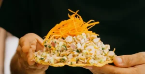 Hand-held ceviche tostada with fresh seafood and citrus