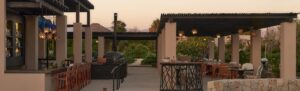 Panoramic view of Botánica at sunset with bar, wood-fired oven and pergola dining