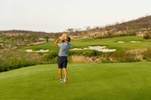 Golfer playing the Tom Fazio course at Chileno Bay