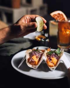 Baja fish tacos with red cabbage slaw and chipotle, finished with fresh lime