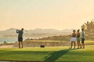 Golfers at sunset on El Dorado's coastal course