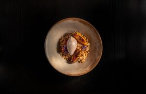 Plated dessert with a quenelle and fire-grilled fruit at Humo, Zadún a Ritz-Carlton Reserve
