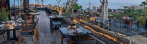 Oceanfront terrace at Humo with a fire trough running between the tables at dusk, Zadún a Ritz-Carlton Reserve