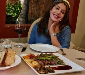 Diner with a sliced-beef plate, grilled vegetables and red wine at Il Forno, San Jose del Cabo
