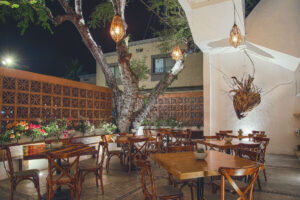 Candlelit courtyard terrace set around the central tree