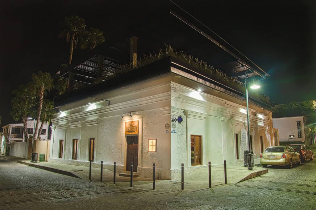 Restored corner facade of the historic house at night