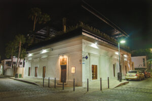 Restored corner facade of the historic house at night