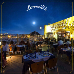 Lorenzillo's outdoor terrace dining at night beside the illuminated Cabo San Lucas marina