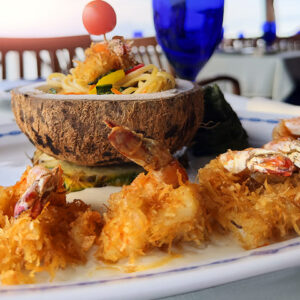 Coconut-crusted shrimp platter served in a coconut shell at Lorenzillo's Cabo San Lucas
