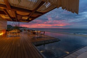 Mako's beachfront deck and infinity pool at sunset over the Sea of Cortez, Solaz a Luxury Collection Resort