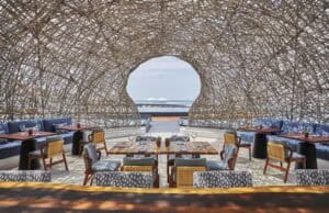 Interior under the woven nest-dome of NIDO looking out through the circular oculus to the Sea of Cortez
