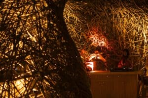 Evening DJ set amid the warmly lit woven nest structure at NIDO, Viceroy Los Cabos