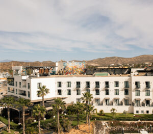 Aerial exterior of Hotel El Ganzo showing the rooftop level and mountain backdrop