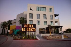 Hotel El Ganzo facade at dusk with the illuminated neon sign and goose emblem