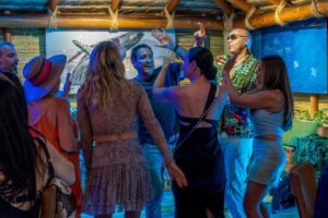 Guests dancing to live music under the palapa at Solomon's Landing