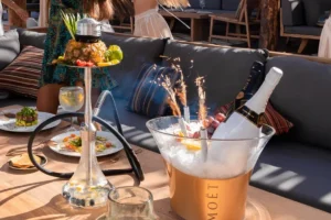 Tabletop with shisha, small plates and a Moet ice bucket lit by Champagne sparklers