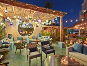 Lounge seating area decorated with glass-float lanterns at Tres Sirenas, Cabo San Lucas