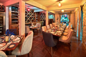 Cava wine-cellar private dining room with tufted chairs at Tres Sirenas, Cabo San Lucas