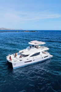 Double-deck Cabo Adventures power catamaran cruising on the Sea of Cortez