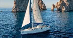 Cabo Adventures Beneteau sailboat cruising in front of the Arch at Land's End