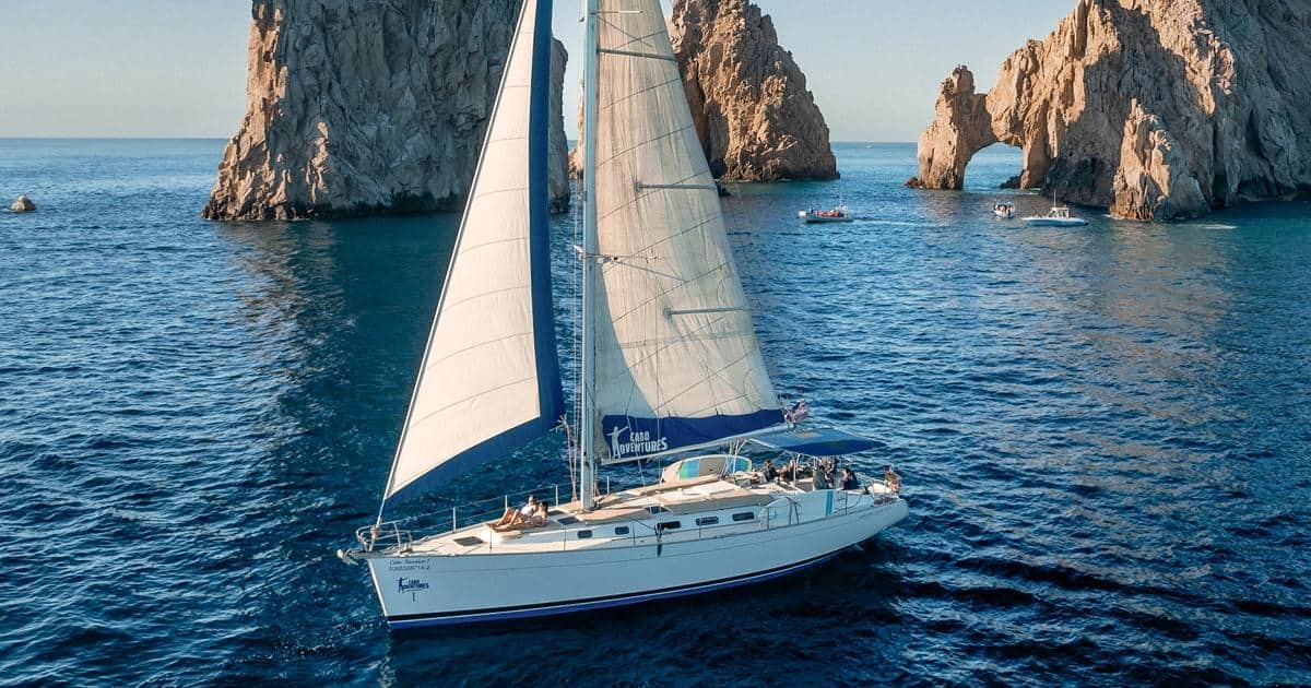 Sailboat cruising in front of the Arch at Land's End in Cabo San Lucas