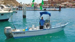 Captain standing aboard the 23-foot Panga Anamar in Cabo San Lucas Marina
