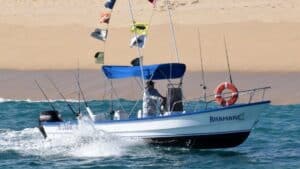 Side view of the Panga Anamar with sun canopy and fishing rods