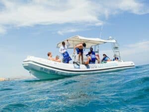 Cabo Expeditions guide and guests beside the Zodiac at a beach stop