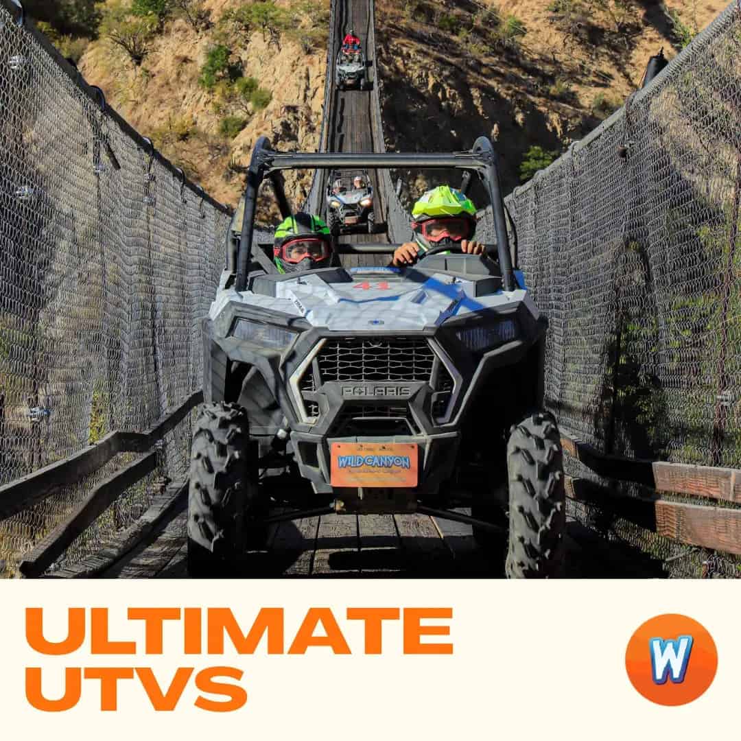 Side-by-side UTV driving on a sandy canyon trail in Los Cabos