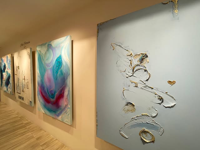 Abstract paintings hung along a gallery wall during the San José del Cabo Art Walk