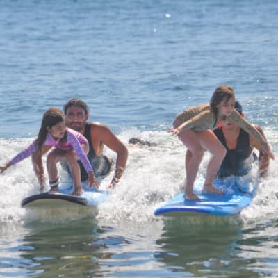 Surfer riding a wave during a lesson at Costa Azul near San Jose del Cabo