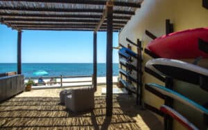 Beginner surfer practicing with a soft-top board at Costa Azul