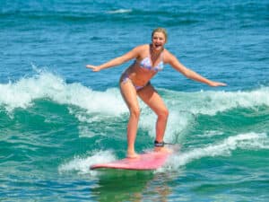 Surf lesson participant riding a small wave near San José del Cabo