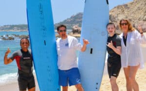 Surf coach and guest entering the water at Costa Azul