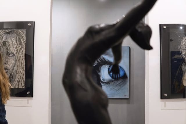 Gallery wall hung with large photographic artworks during the San José del Cabo Art Walk