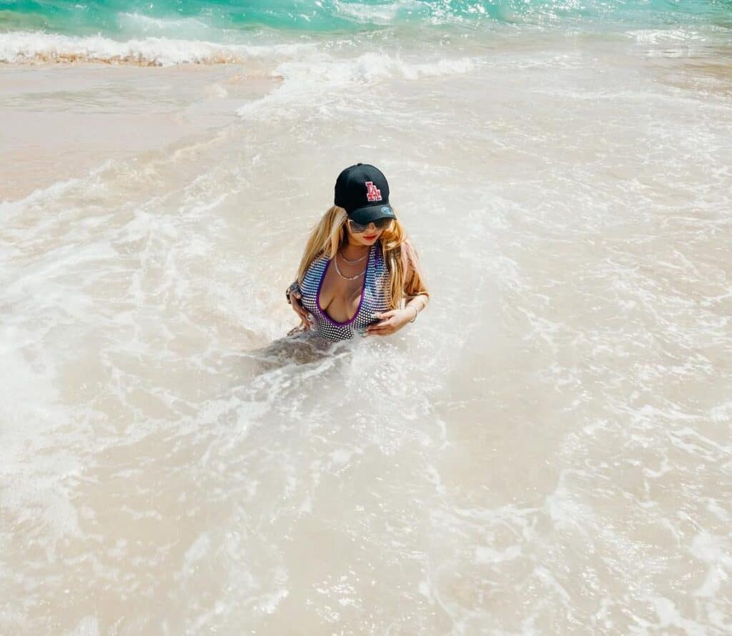 Swimmer in the white foam of a breaking wave on a Los Cabos beach