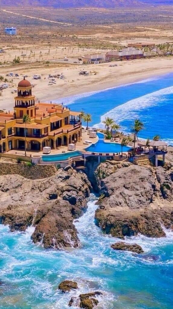 Aerial view of a clifftop resort and the surf at Cerritos Beach near Todos Santos