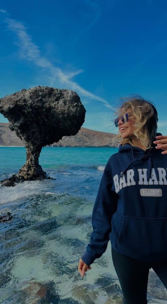 Woman beside the mushroom-shaped rock at Balandra Beach