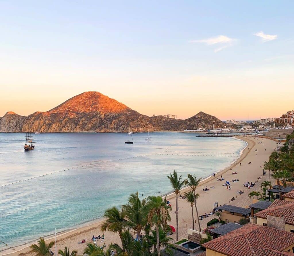 Aerial view of Medano Beach in Cabo San Lucas with a tall ship anchored offshore