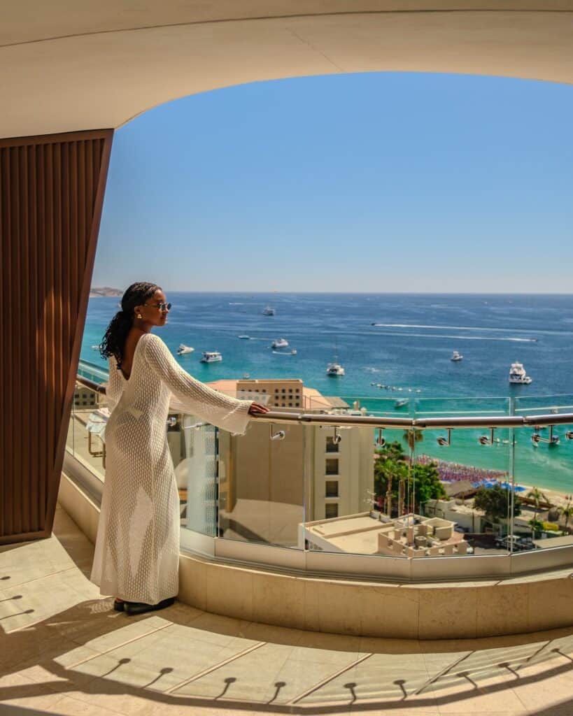 A guest on a balcony looking over the bay and the marina